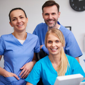 Team of happy stomatologists in dentist's clinic